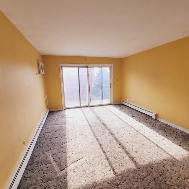 empty room featuring carpet floors, baseboard heating, and a wall mounted air conditioner