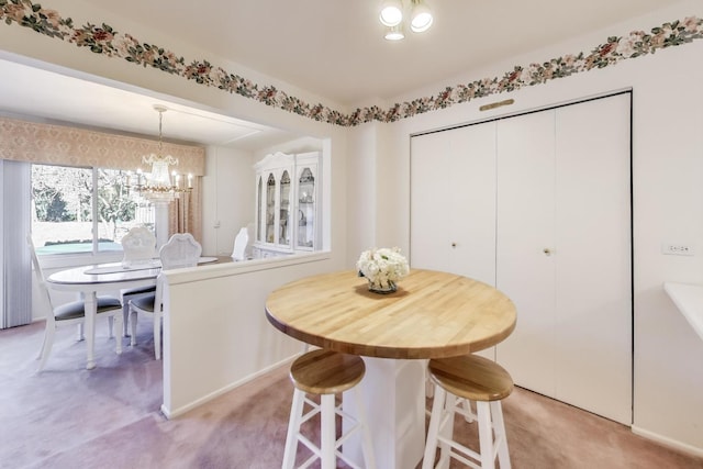 carpeted dining area featuring an inviting chandelier