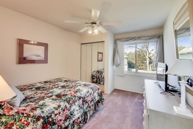 bedroom featuring ceiling fan, light colored carpet, and a closet