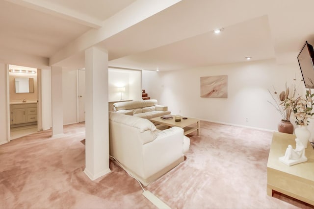 carpeted living room with beam ceiling