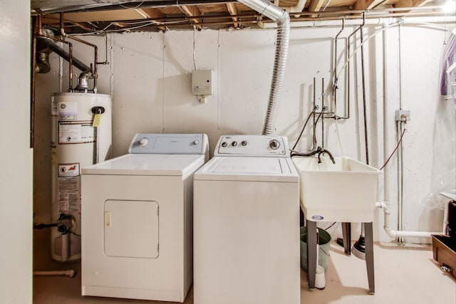 washroom featuring sink, gas water heater, and washing machine and dryer