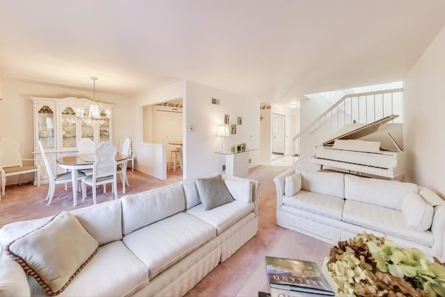 carpeted living room featuring a notable chandelier