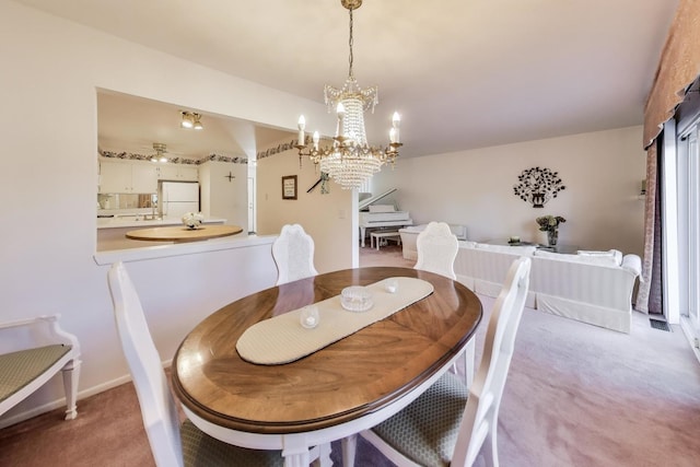 carpeted dining space with a notable chandelier