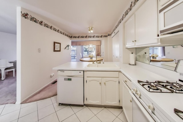 kitchen with sink, white cabinetry, light tile patterned floors, kitchen peninsula, and white appliances