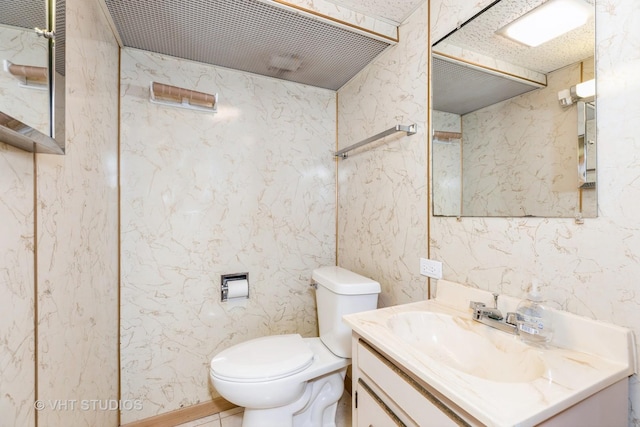 bathroom with toilet and vanity