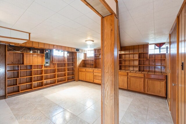 kitchen with tile countertops and wooden walls