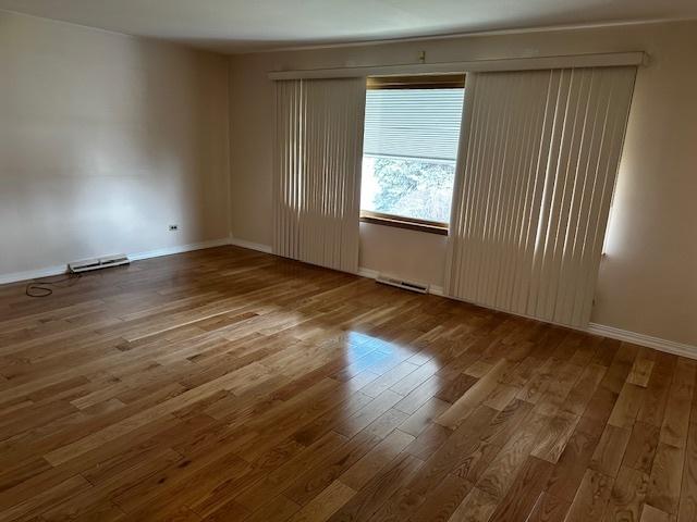 empty room with wood-type flooring