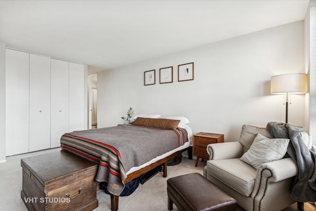 bedroom with light carpet and a closet