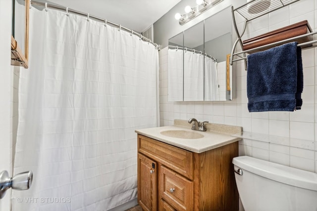 bathroom with toilet, vanity, tile walls, tasteful backsplash, and curtained shower