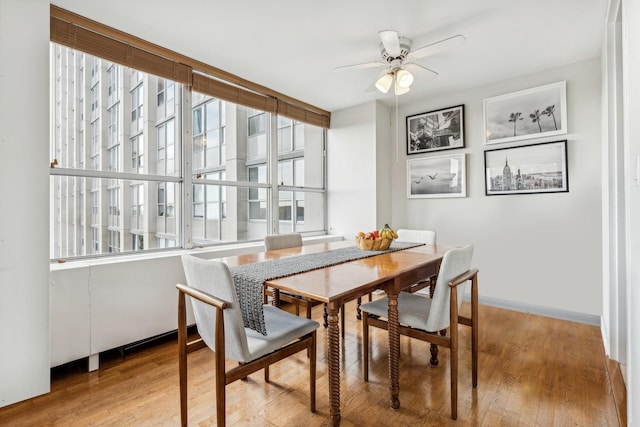 dining room with light wood-type flooring and ceiling fan