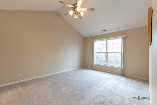 spare room featuring light carpet, ceiling fan, and vaulted ceiling