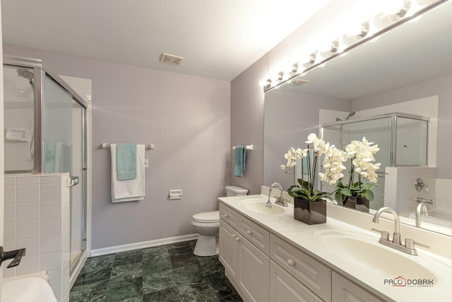 bathroom with walk in shower, vanity, and toilet