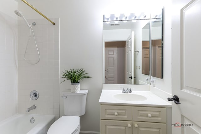 full bathroom with toilet, vanity, and tiled shower / bath