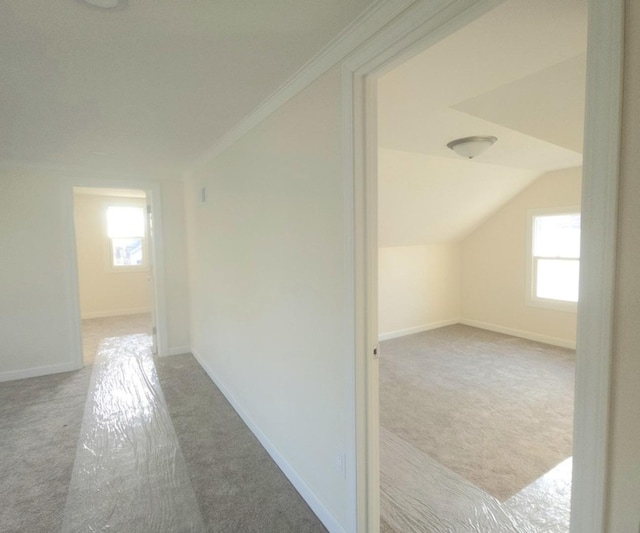 bonus room featuring lofted ceiling and light colored carpet