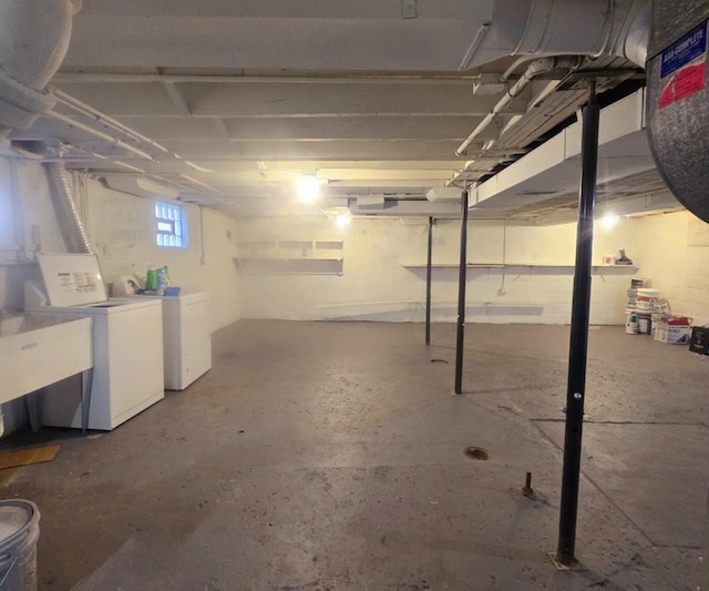 basement featuring washing machine and dryer and sink