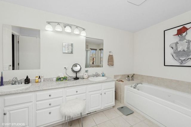 bathroom featuring tile patterned flooring, vanity, and a tub to relax in