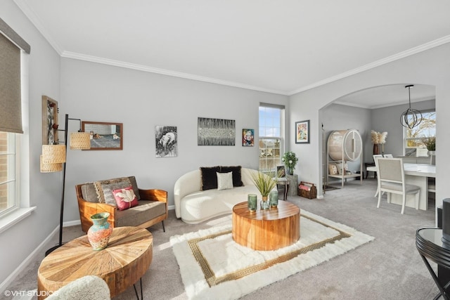 carpeted living room featuring ornamental molding