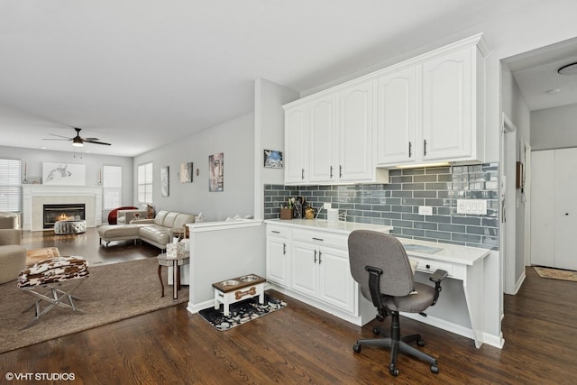 interior space with dark wood-type flooring and ceiling fan