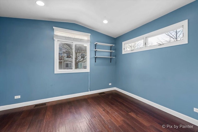 unfurnished room with hardwood / wood-style flooring and lofted ceiling