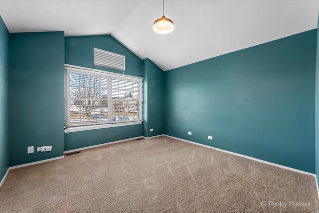 empty room featuring vaulted ceiling and carpet floors