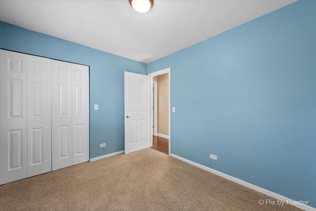 unfurnished bedroom featuring a closet and carpet flooring