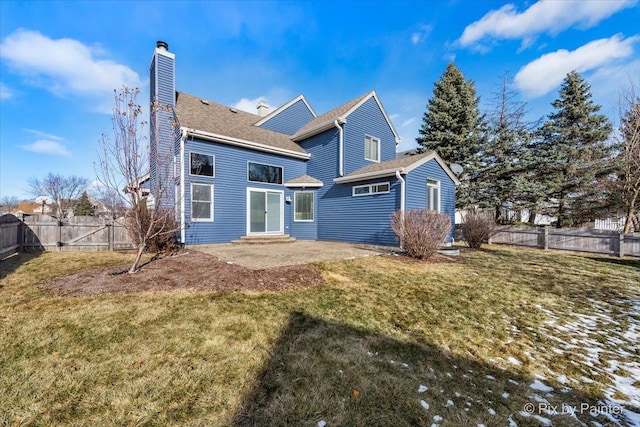 rear view of property with a patio area and a lawn