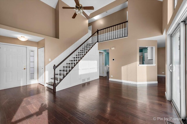 entryway featuring dark hardwood / wood-style floors, a high ceiling, and ceiling fan