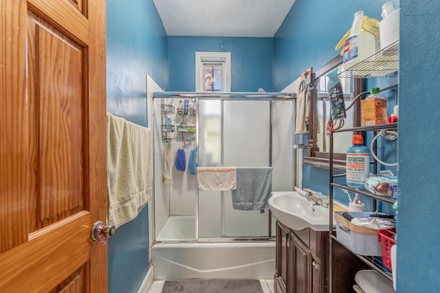 bathroom with bath / shower combo with glass door and vanity