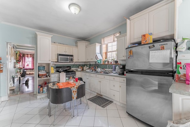 kitchen with stainless steel appliances, backsplash, light tile patterned flooring, ornamental molding, and sink