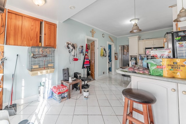 kitchen with light tile patterned flooring and crown molding