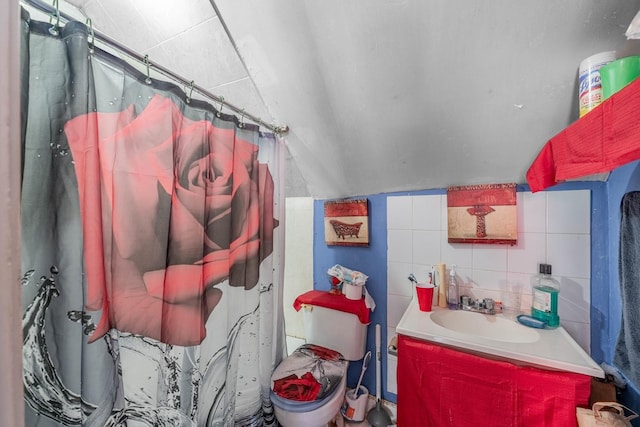 bathroom featuring toilet, vanity, tile walls, tasteful backsplash, and a shower with curtain