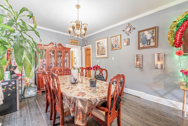 dining space with dark hardwood / wood-style flooring, crown molding, and a notable chandelier