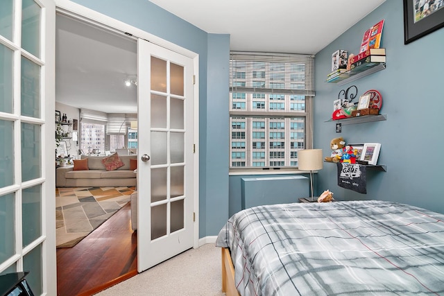 carpeted bedroom featuring french doors