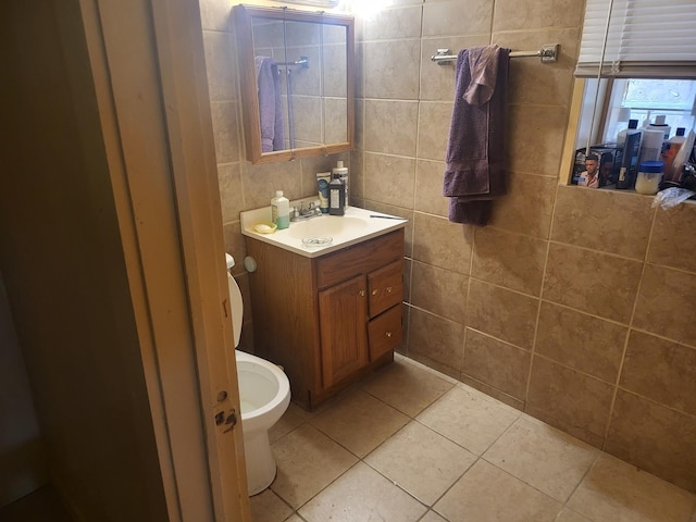 bathroom with toilet, tile patterned flooring, and vanity