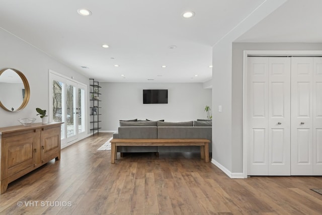 bedroom featuring hardwood / wood-style flooring, access to exterior, a closet, and french doors