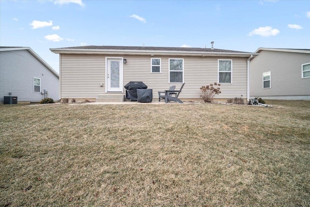 back of house featuring cooling unit and a yard