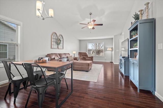 dining space featuring dark hardwood / wood-style floors and ceiling fan with notable chandelier