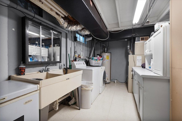 laundry room featuring sink, gas water heater, cabinets, and washing machine and clothes dryer