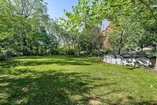 view of yard with a covered pool