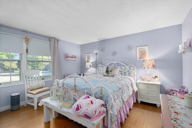 bedroom with light hardwood / wood-style floors