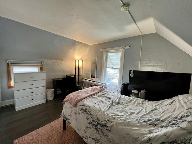 bedroom with lofted ceiling and dark hardwood / wood-style floors