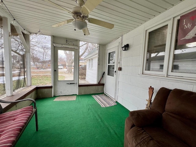 sunroom / solarium featuring ceiling fan