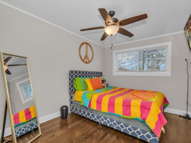 bedroom featuring ceiling fan, crown molding, and dark hardwood / wood-style floors