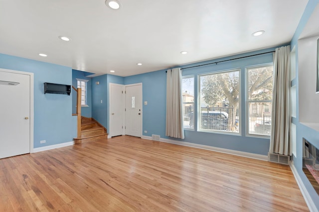 unfurnished living room featuring light hardwood / wood-style flooring