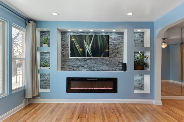 interior space with light wood-type flooring and built in shelves