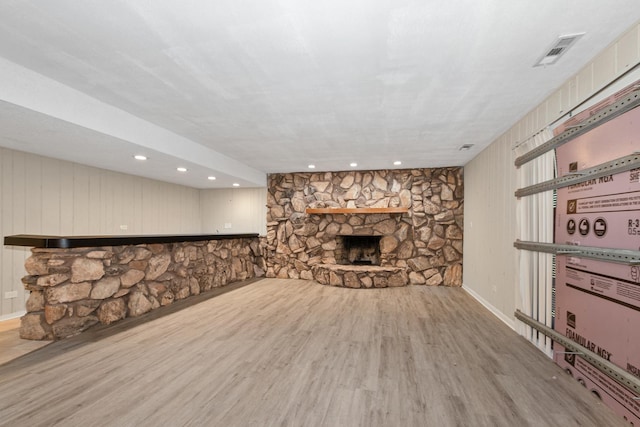 unfurnished living room with a fireplace and light hardwood / wood-style floors