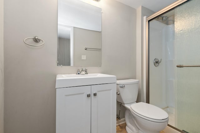 bathroom with vanity, toilet, and an enclosed shower