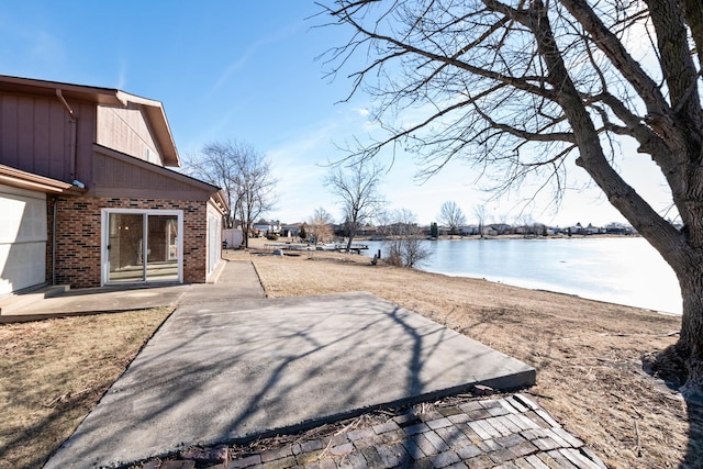 view of yard with a patio and a water view