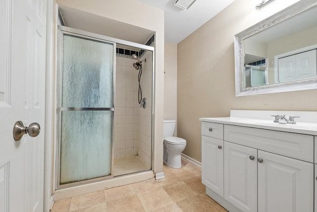 bathroom featuring vanity, toilet, and walk in shower