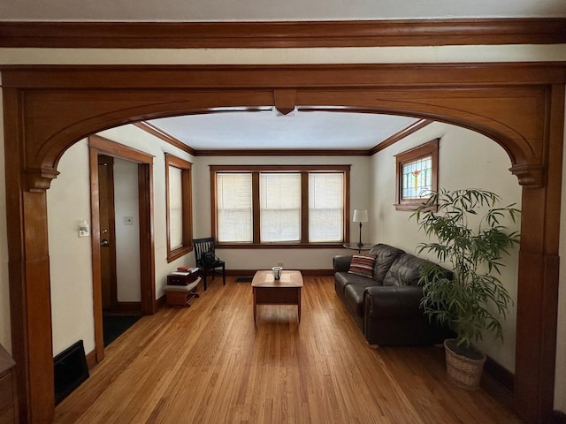 interior space with crown molding and light wood-type flooring